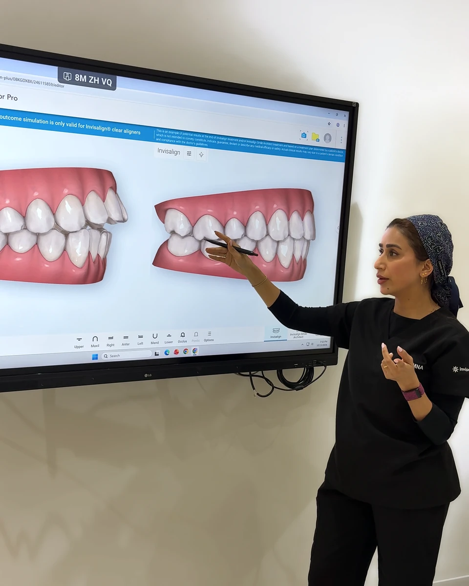 Dr Amna Ali at the Invisalign Outcome Simulator in her clinic, explaining the simulated result on screen